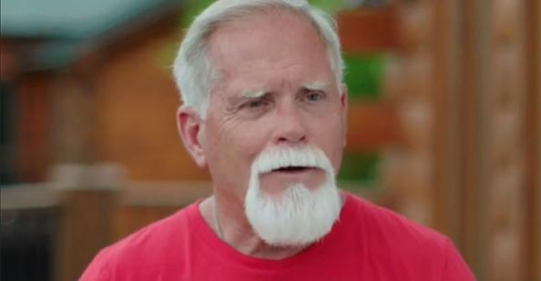 Dusty Baxley facing the camera in a red t-shirt